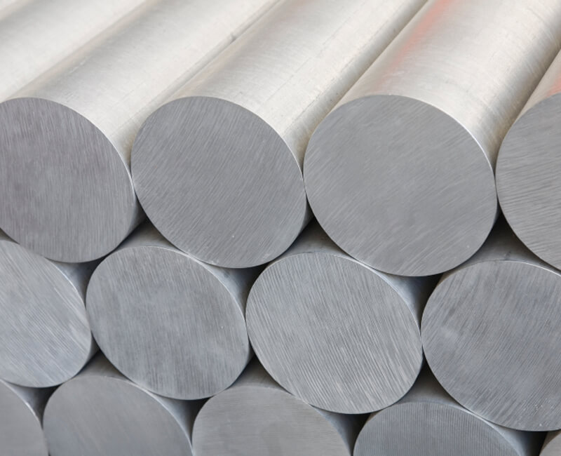 Stack of round aluminum rods with a brushed metallic surface.