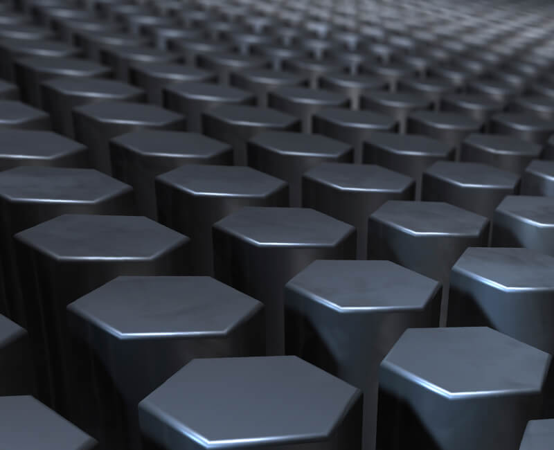 Close-up view of a grid of hexagonal carbon steel rods with a reflective surface.