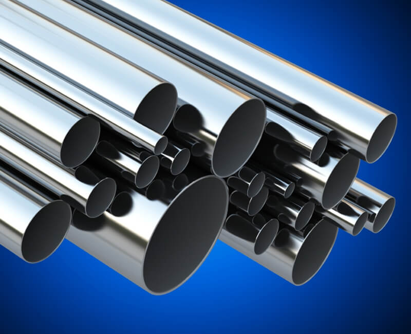 Bundle of shiny nickel tubes of varying diameters with a reflective surface against a blue background.